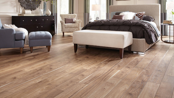 warm wood look laminate flooring in a classy bedroom